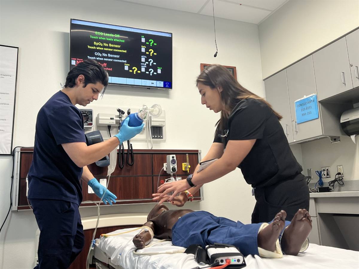 Applying oxygen to training mannequin.